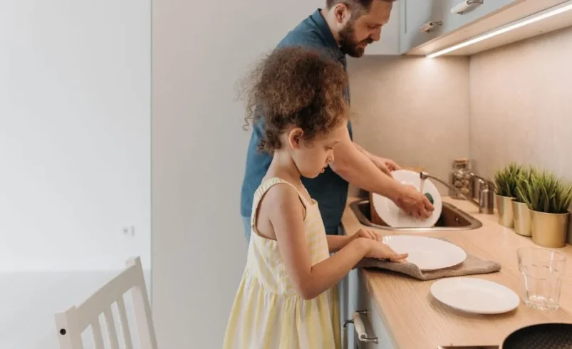 Child refusing help while trying to manage an everyday task independently