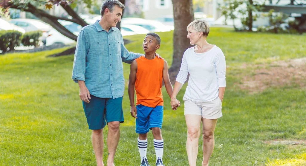 Parent and child talking naturally during an evening walk